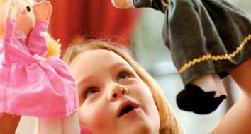 Girl playing with dolls